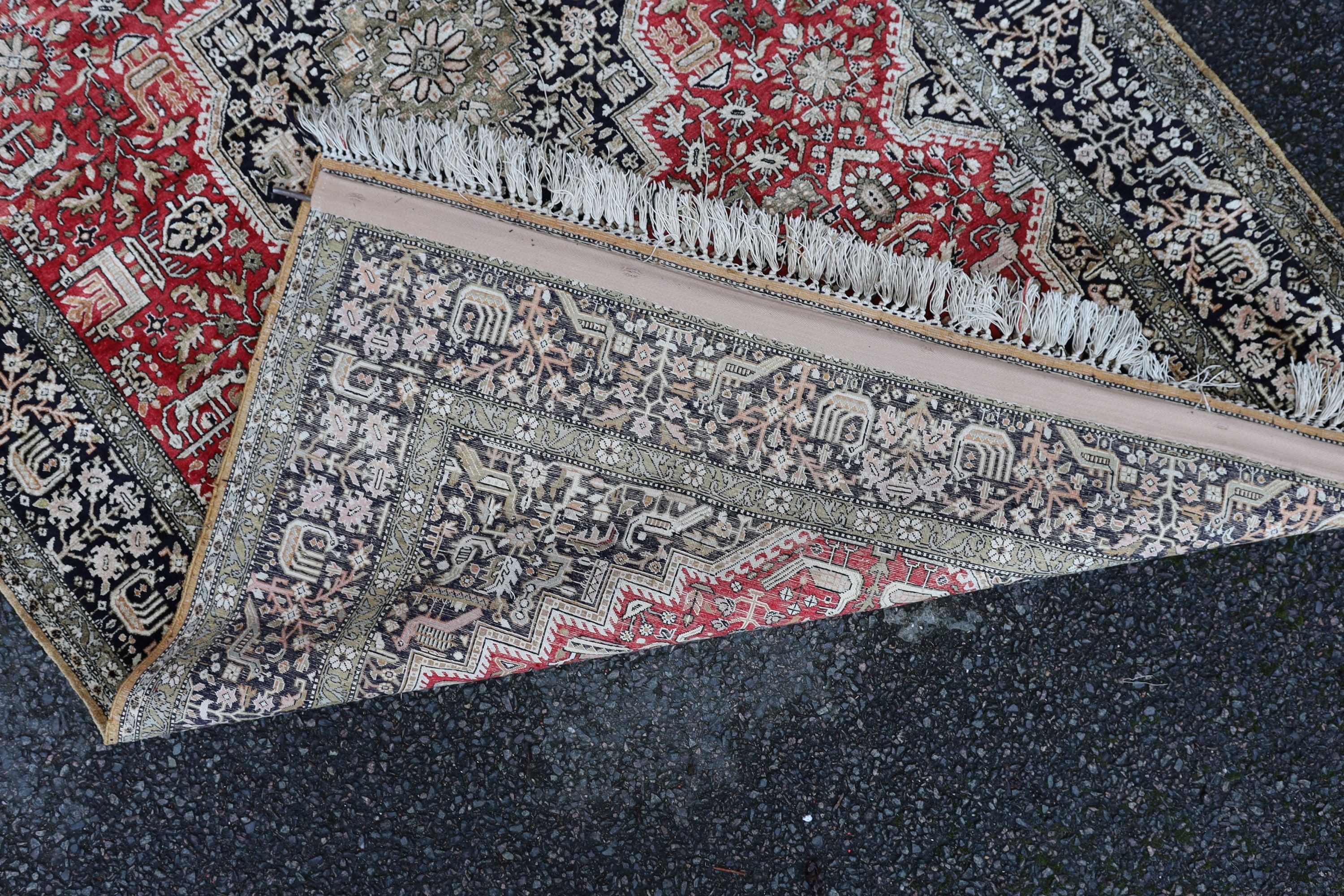 An early 20th century Caucasian silk red ground rug, 206 x 132cm.